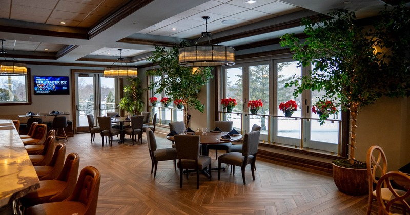 Interior seating area with a bar area, tables and chairs
