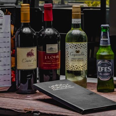 Lined up wine and beer bottles.