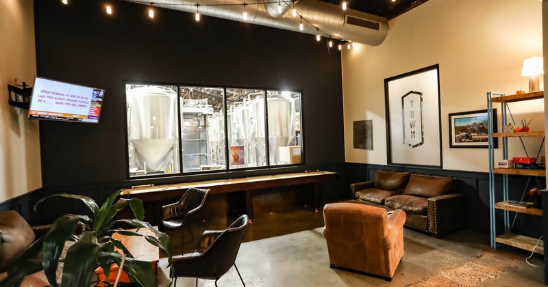 Interior, long table, chairs and couch, tv on the wall