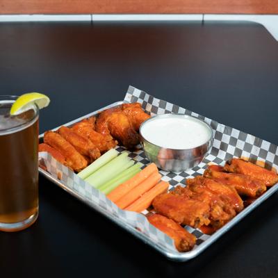 Buffalo wings, with celery, carrots, and dip.