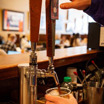 Beverage being poured from the tap into a glass.