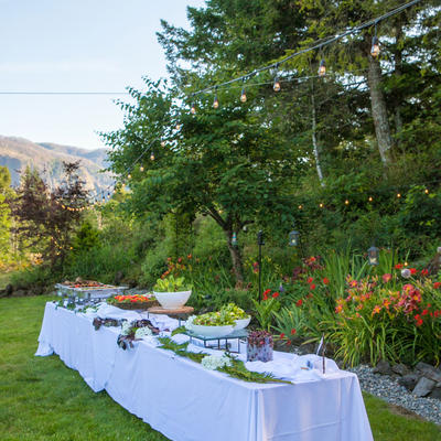 Table with food lined up with natural landscape in the back