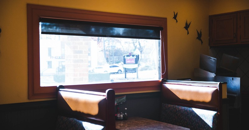 A restaurant booth next to a large window