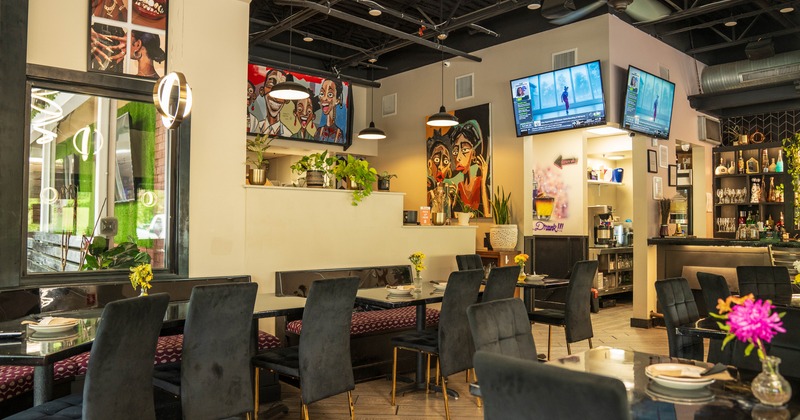 Diner tables, chairs, tv screens above