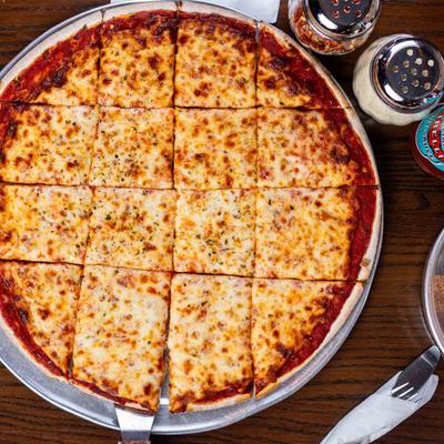 Chicago style thin crusted pizza served on a table, overhead view.
