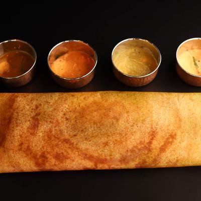 A traditional combination of crispy Masala Dosa served with hot vegetable lentil stew and chutney.