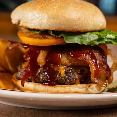 Rodeo Burger with bacon, tomato, and onion rings.