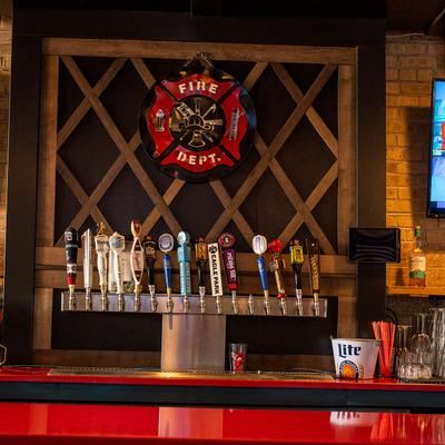 Interior, bar detail, beer taps and  wall TV sets