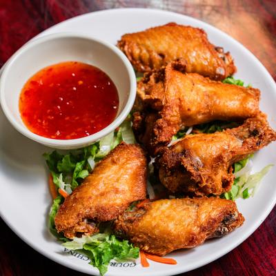 Crispy fried chicken wings served over lettuce with a cup of sweet chili sauce.
