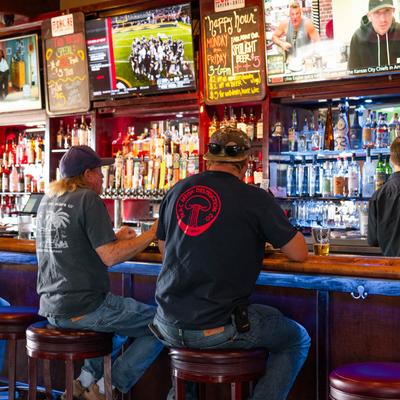 Customers sitting at the bar.