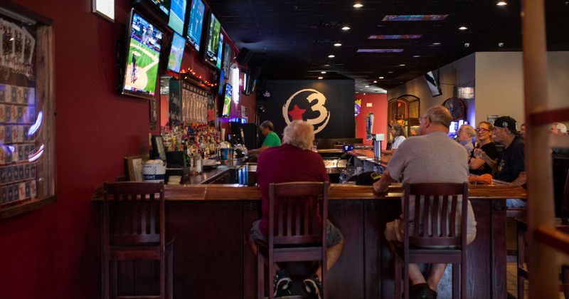 Interior, guests sitting at the bar