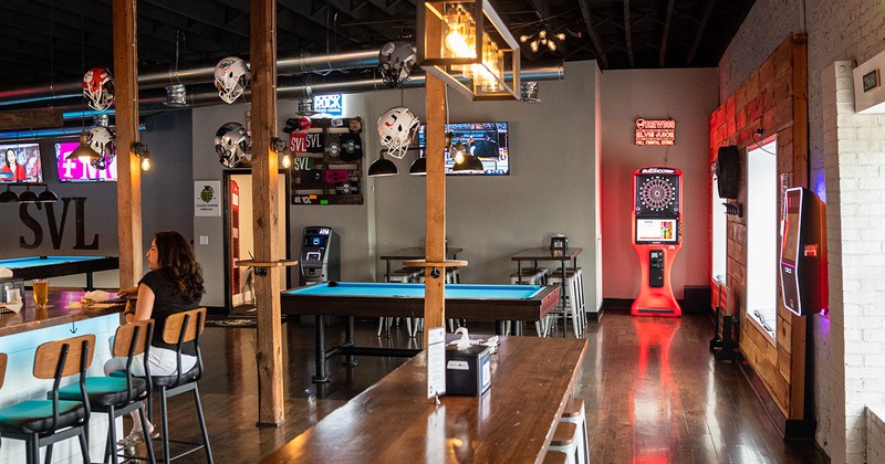 Interior bar area, pool table, dartboard machine, TVs