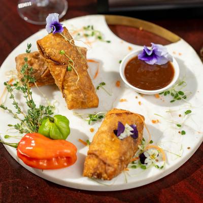 Mac and Cheese Egg Rolls with a sauce dip.