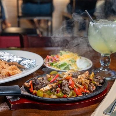 Fajitas, cocktail, wedge behind.