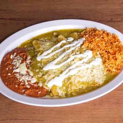 Chicken enchiladas with green salsa, rice, and beans.