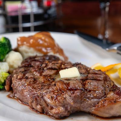 Rib eye with steamed vegetables and mashed potatoes, close up.