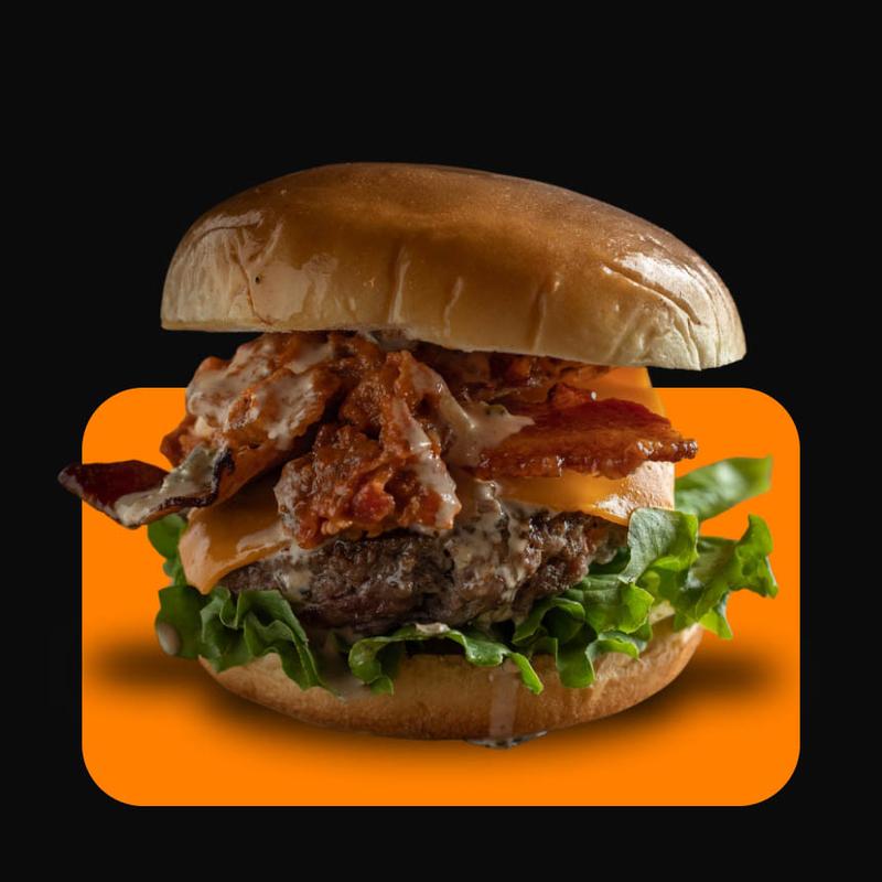 Cheeseburger with crispy bacon, lettuce, and sauce.