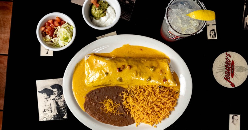 Smothered burrito, served with rice, and refried beans