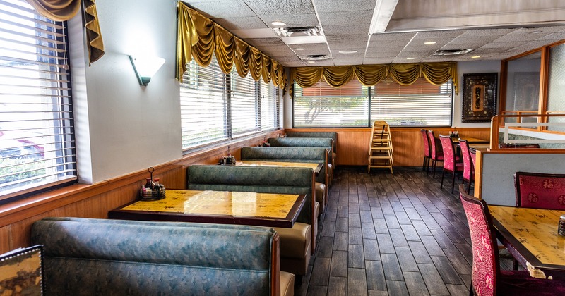 Interior dining area with dining booths lined up along windows