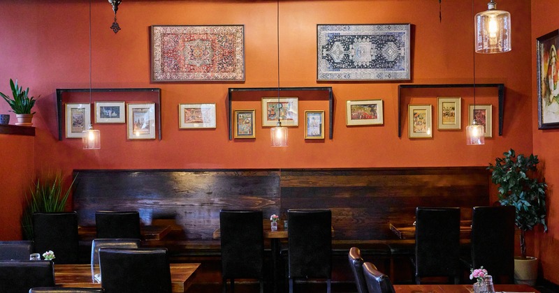 Interior, dining area, long wooden banquette bench with tables, seating for six people