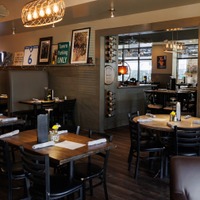 Modern and cozy interior dining area with set tables.
