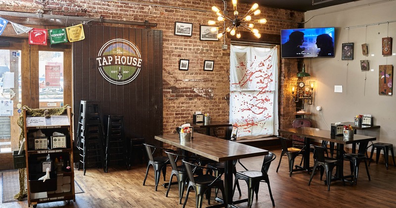 Interior, restaurant logo on a wooden sliding door, tables, chairs, decorations, TV