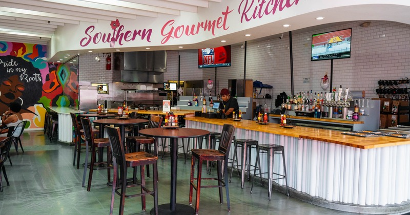 Interior with a bar, seating area and colorful mural