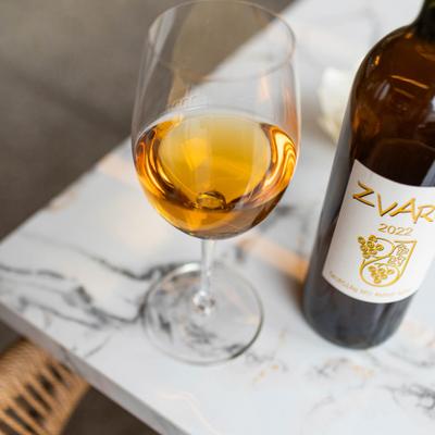 bottle and glass showing the orange color of Georgian amber or 'orange' wine