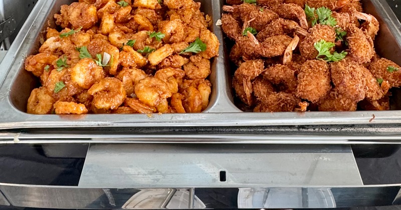 Trays of fried shrimp in buffet warmers