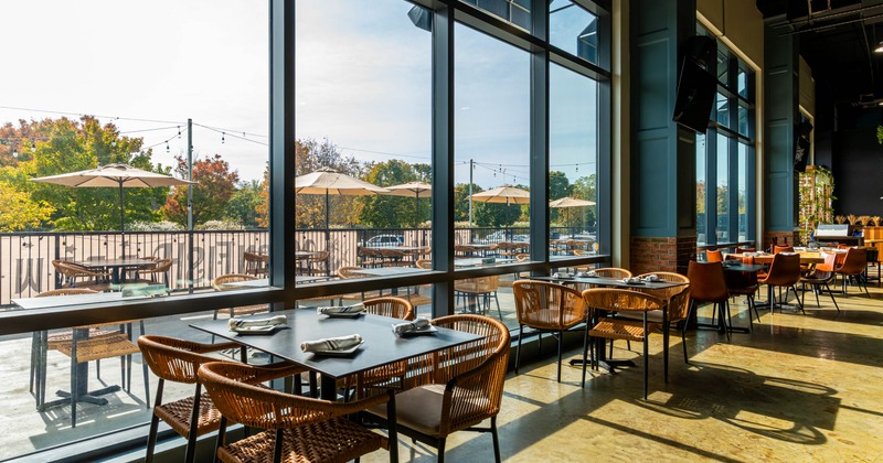 Inside, large windows and patio view featuring tables and umbrellas