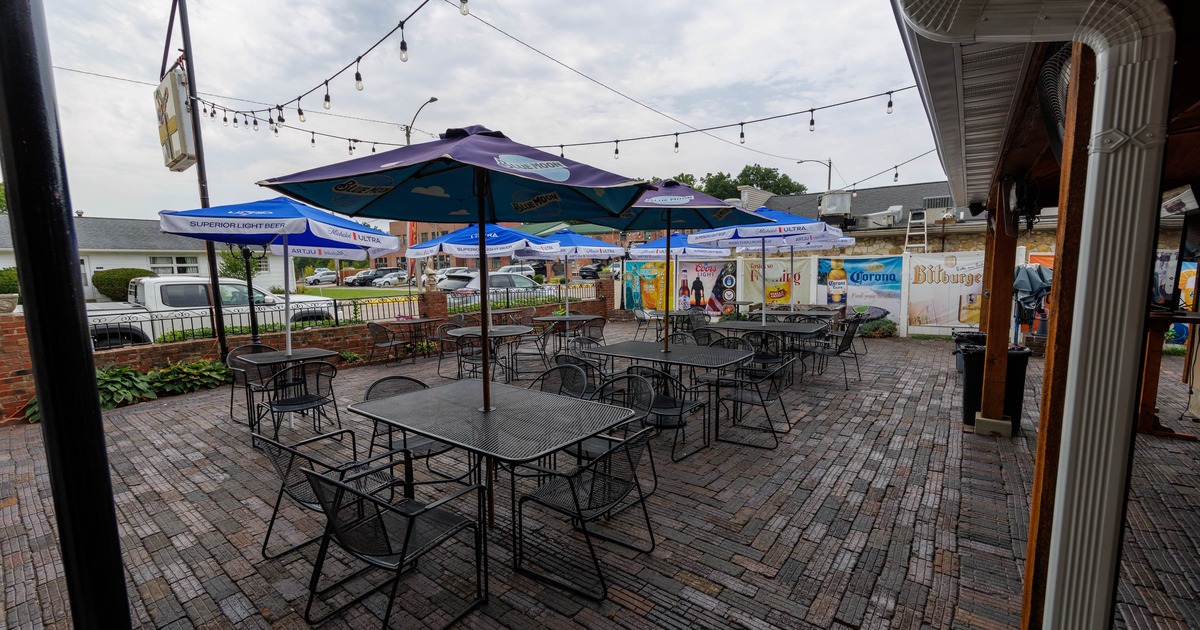 Outdoor dining area with black metal tables and chairs