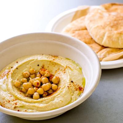 Hummus Bowl topped with chickpeas and served with pita bread.