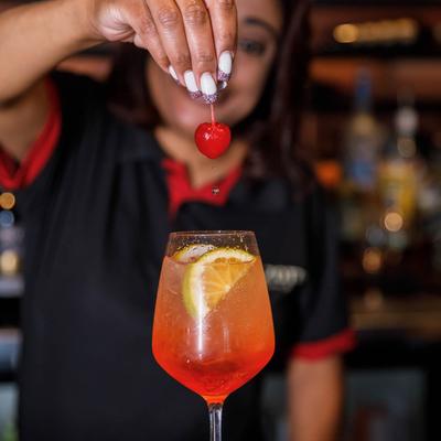 Bartender making Aperol Spritz.