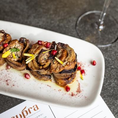 Eggplant rolls with walnut filling on rectangular white plate