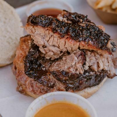 Brisket sandwich served with sides.