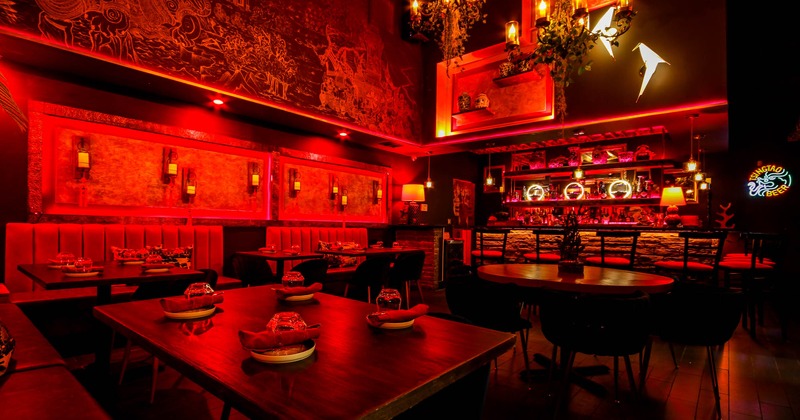 Inside, seating area with red lights, bar area in the back