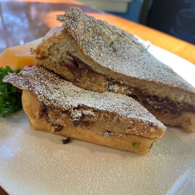 A Nutella-stuffed French toast dusted with powdered sugar.