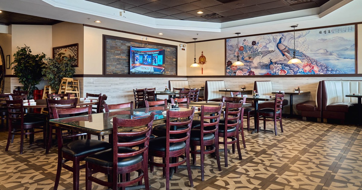 Interior, dining area, long table setup for nine people, booths, tile flooring