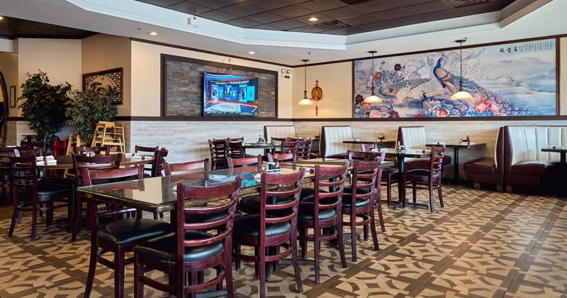 Interior, dining area, long table setup for nine people, booths, tile flooring