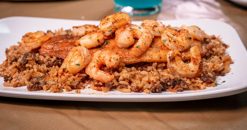 Cajun-style blackened fish topped with seasoned sauteed shrimp, served over dirty rice