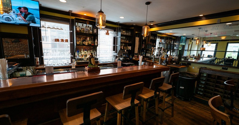 Bar area, neatly lined up bar stools