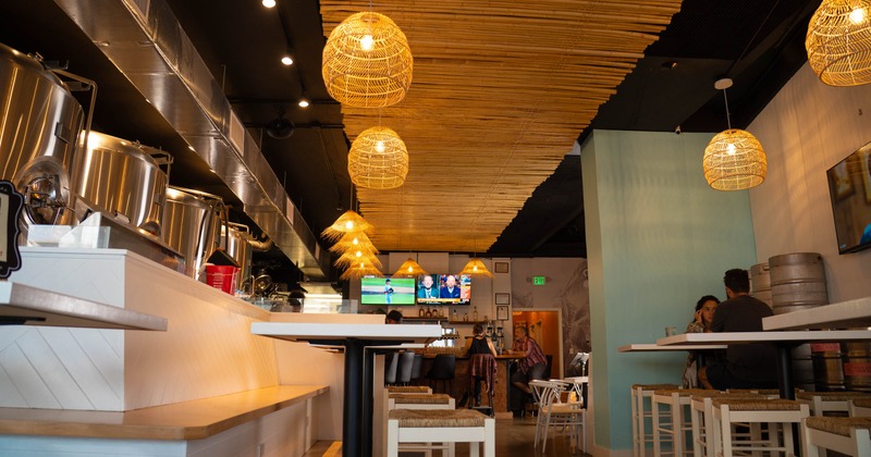 Interior with warm, woven pendant lights and modern industrial decor