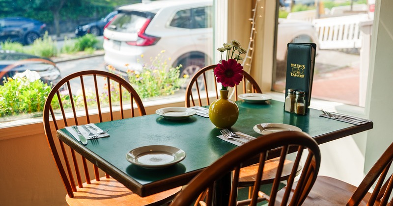 Dining table by the window set for four guests