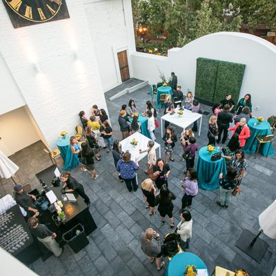 A far shot of guests outside on the patio.