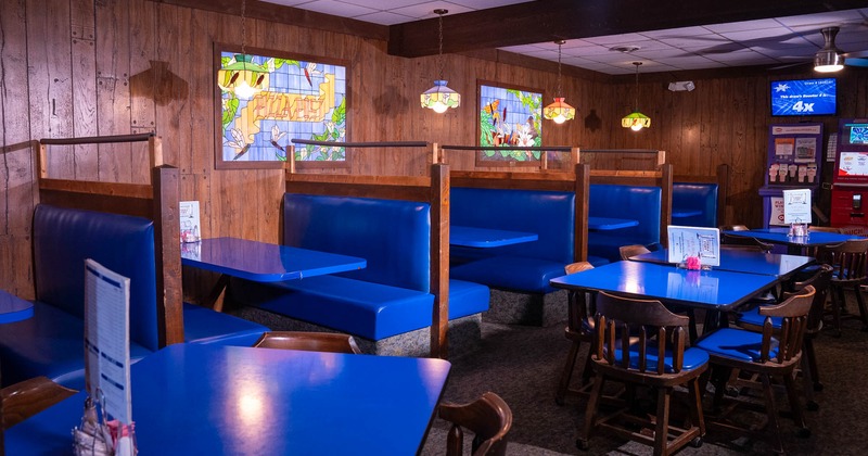 Interior, dining area, seating booths, tables with chairs, wood coated walls