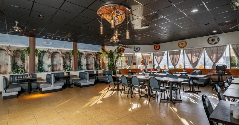 Interior, open space dining area, regular seating tables and booths, tile flooring