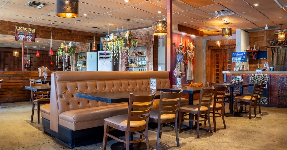 Modern and cozy interior seating area with tables, chairs and upholstered seats