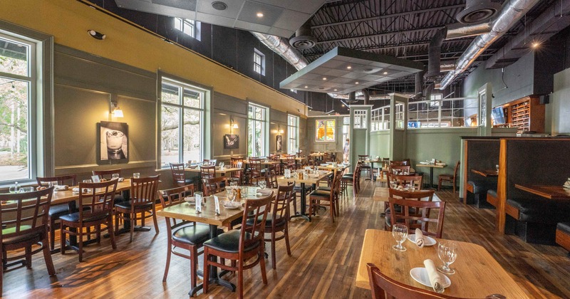 Interior, lined up dining tables with tableware, waiting for guests