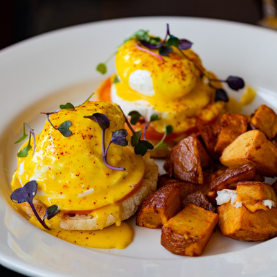 Caprese Benedict with roasted red potatoes.