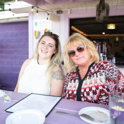 Exterior, two guests at a table, photo portrait.